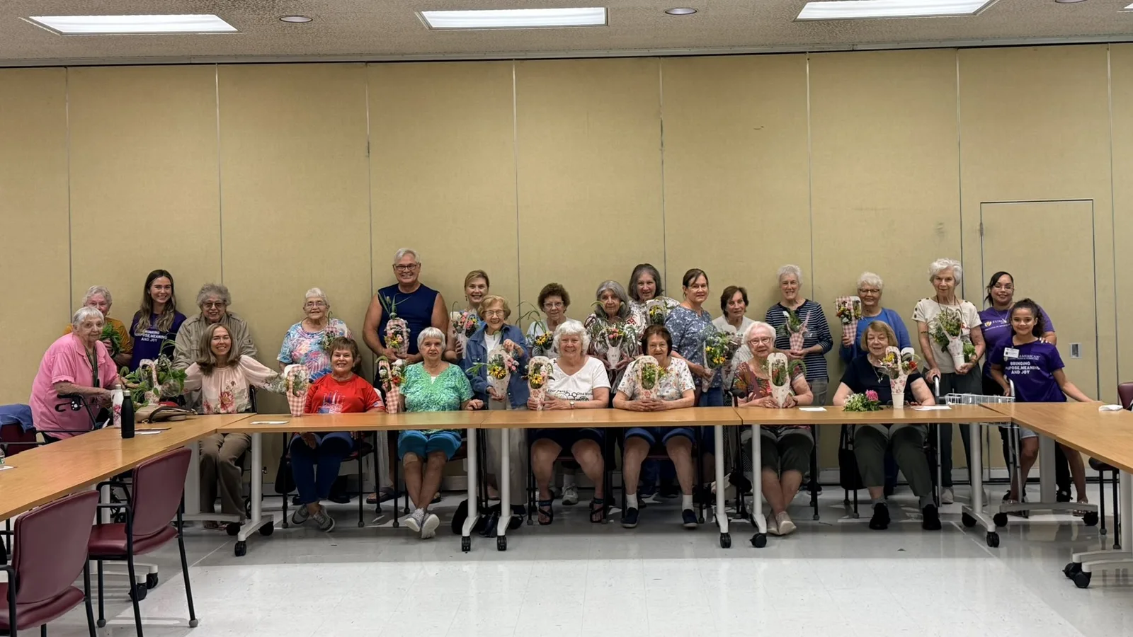 Members of the Berlin Senior Center with the flower arrangements they made in a Euro-American craft class