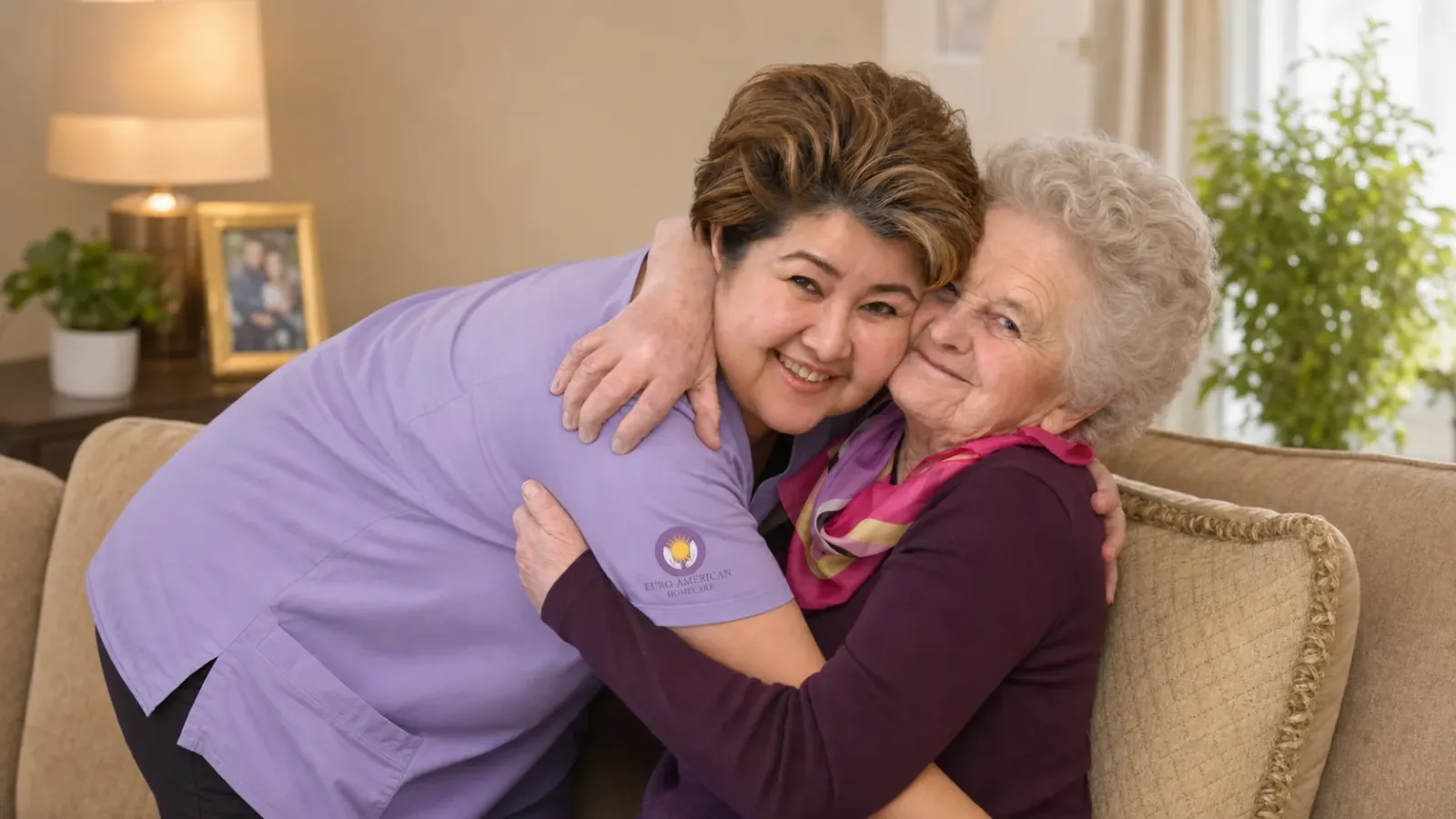 Caregiver embracing a smiling senior woman