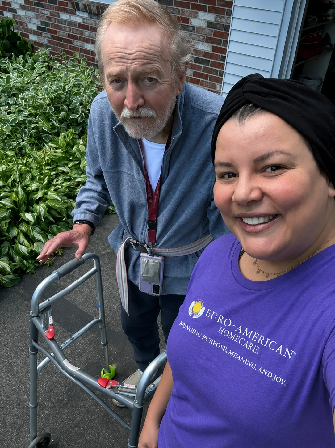 A caregiver and client enjoying time outdoors during June's Moments of Joy activity