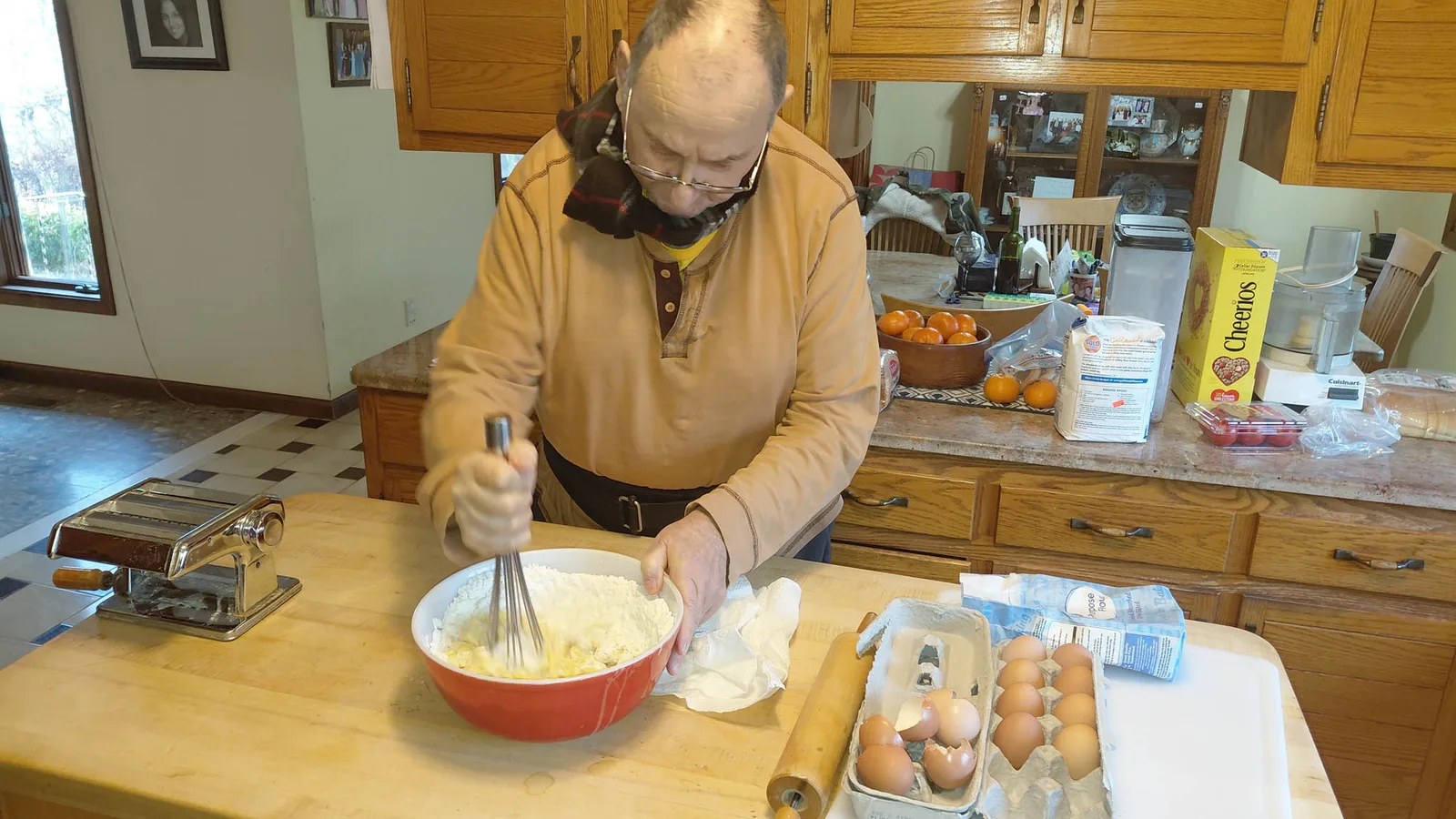 A client mixing dough at his kitchen table during a baking activity
