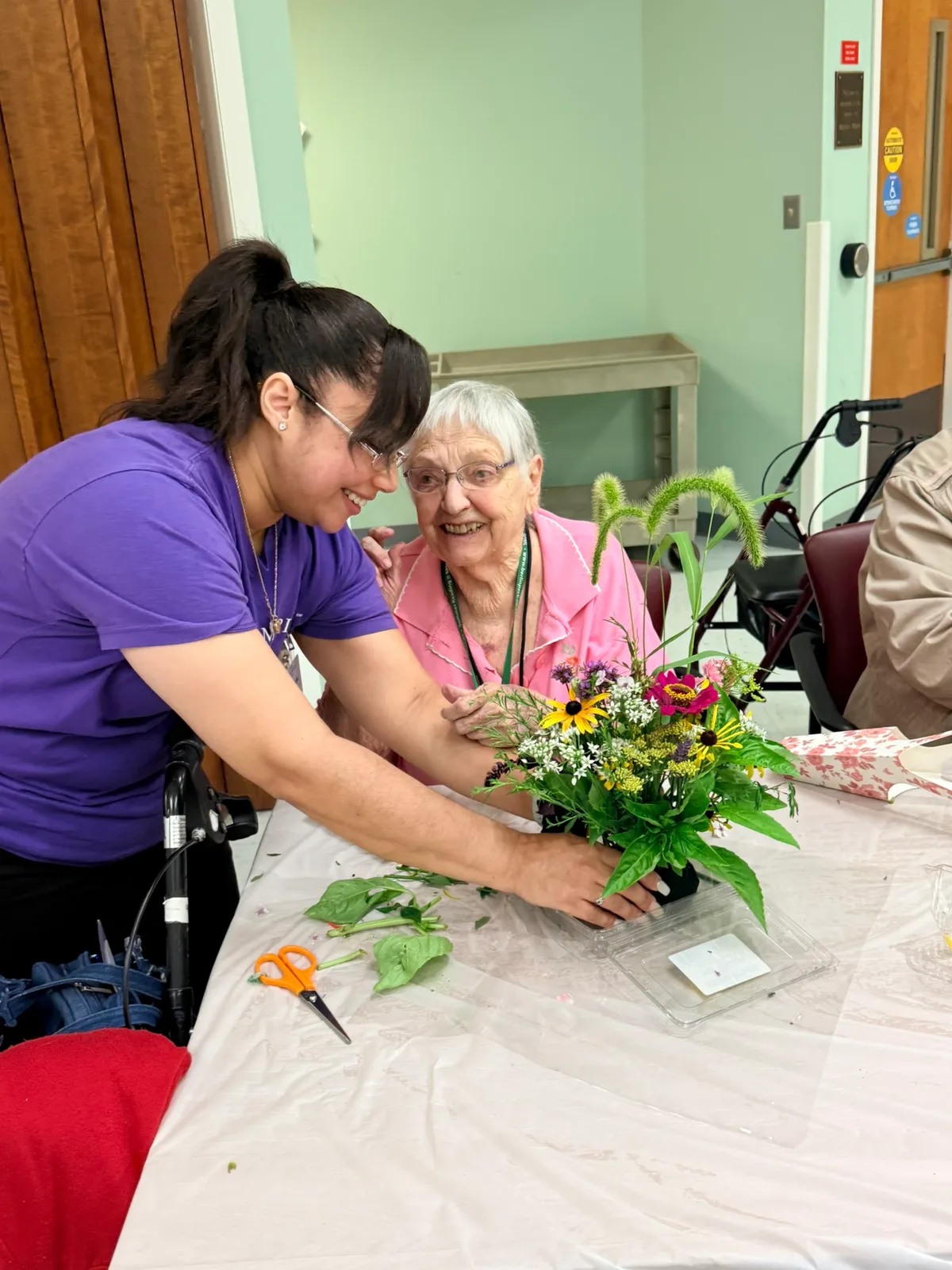 A client and our team member working on a craft project together