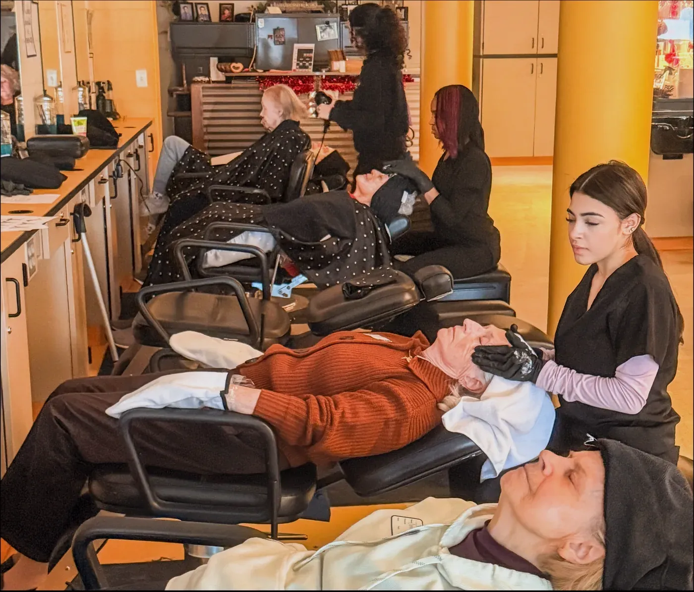 Clients and caregivers at the senior spa day hosted with E.C. Goodwin Technical High School