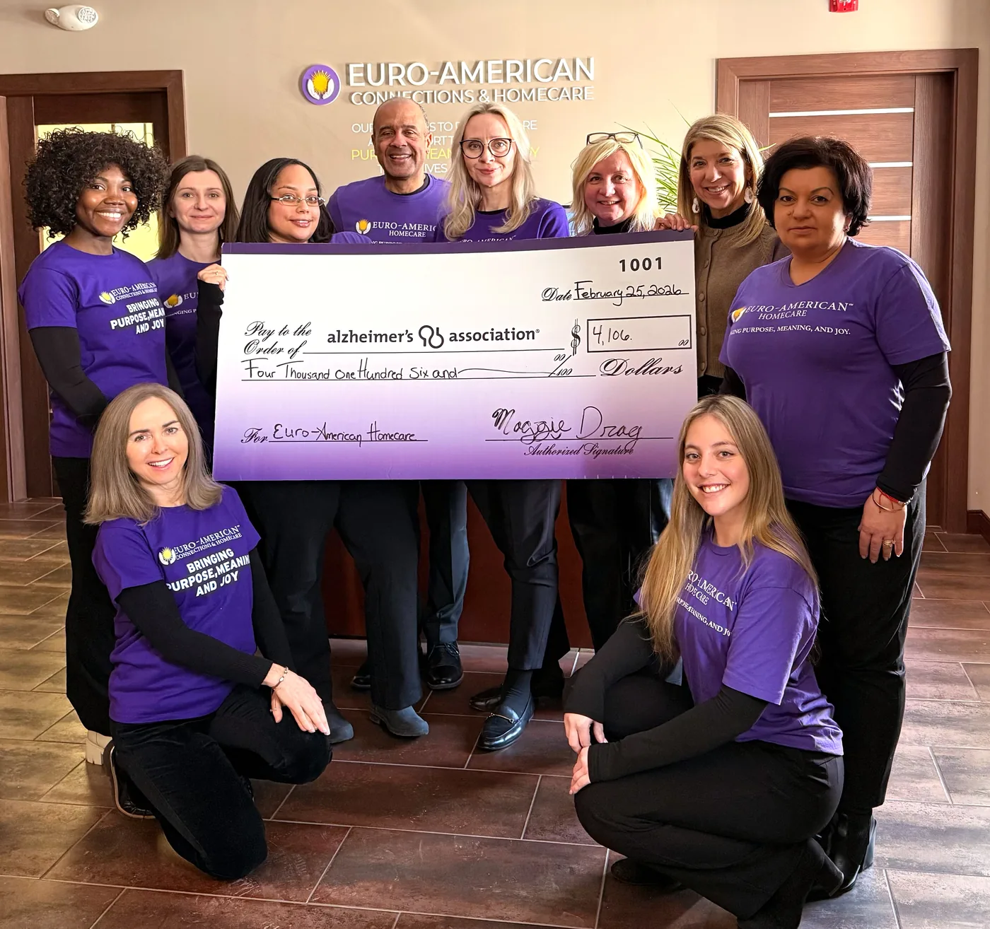 Euro-American Homecare team with a check for the Alzheimer's Association